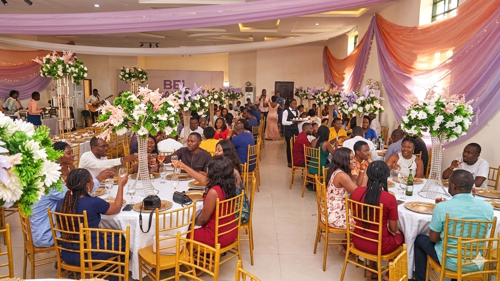 Guests seated around tables in the hall